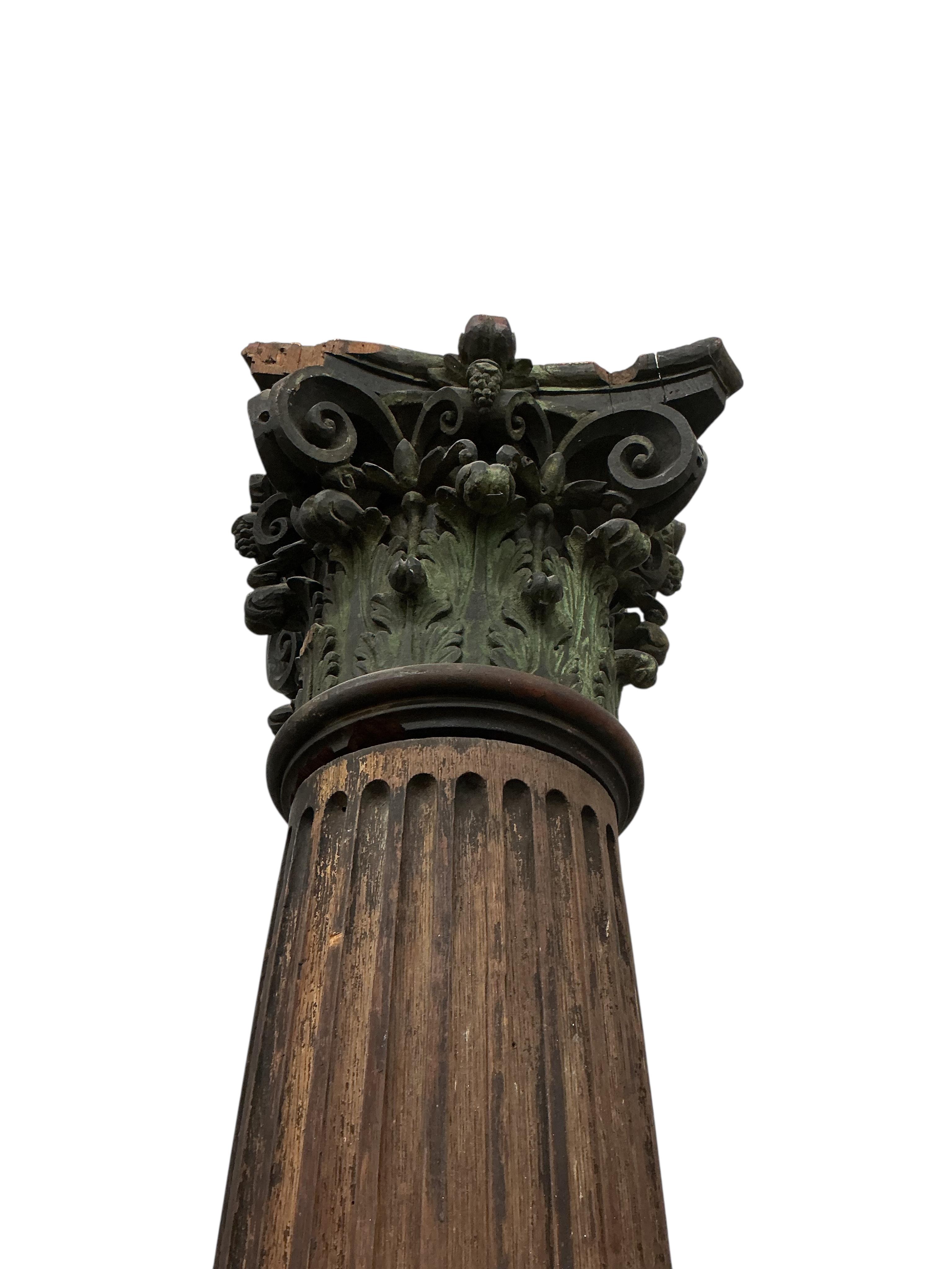 A pair of 17th century oak Corinthian columns, of large size, height 279cm, by repute from St Mary le Bow, designed by Christopher Wren